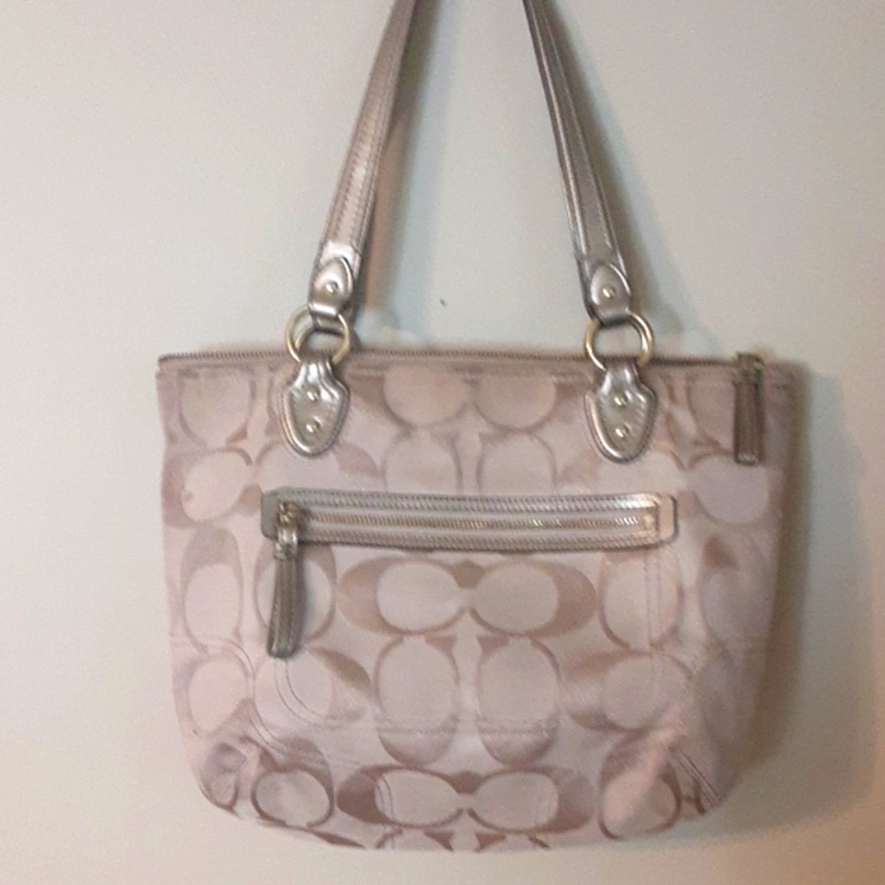 Coach bag tan and gold exterior with watermelon pink interior. Good condition